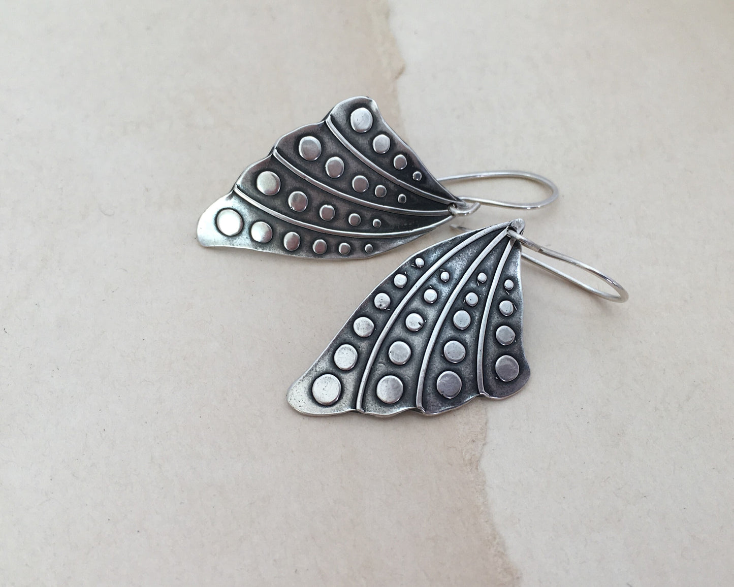 Silver butterfly wing earrings with polka dots