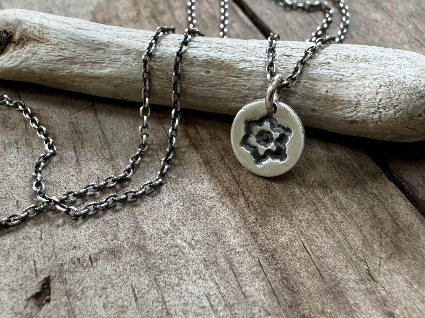 Tiny stamped flower necklace in oxidized sterling silver