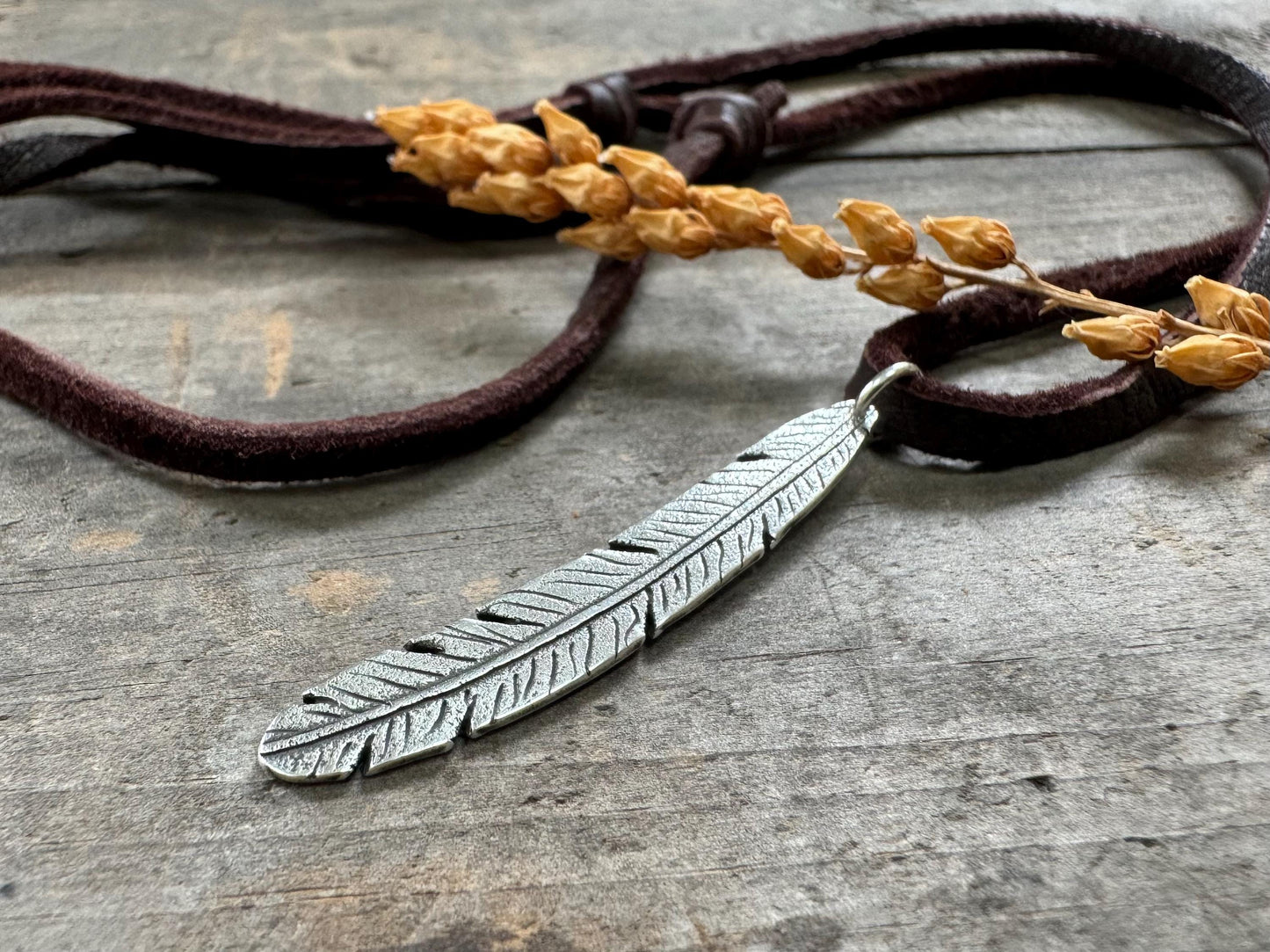 Tribal style silver feather necklace on leather or chain