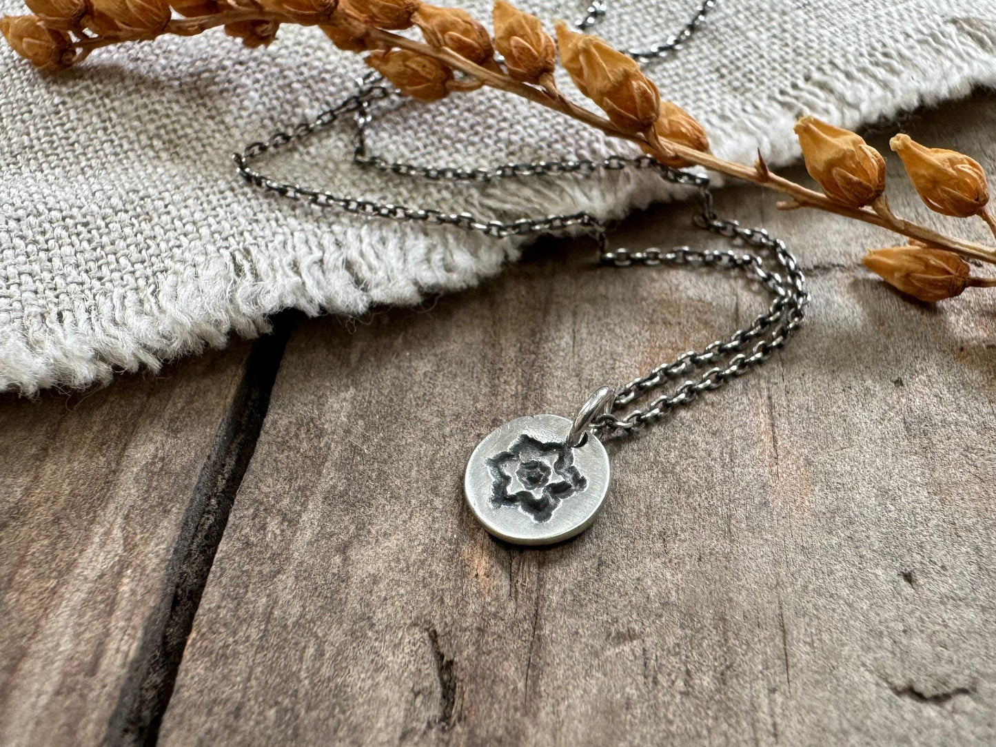 Tiny stamped flower necklace in oxidized sterling silver