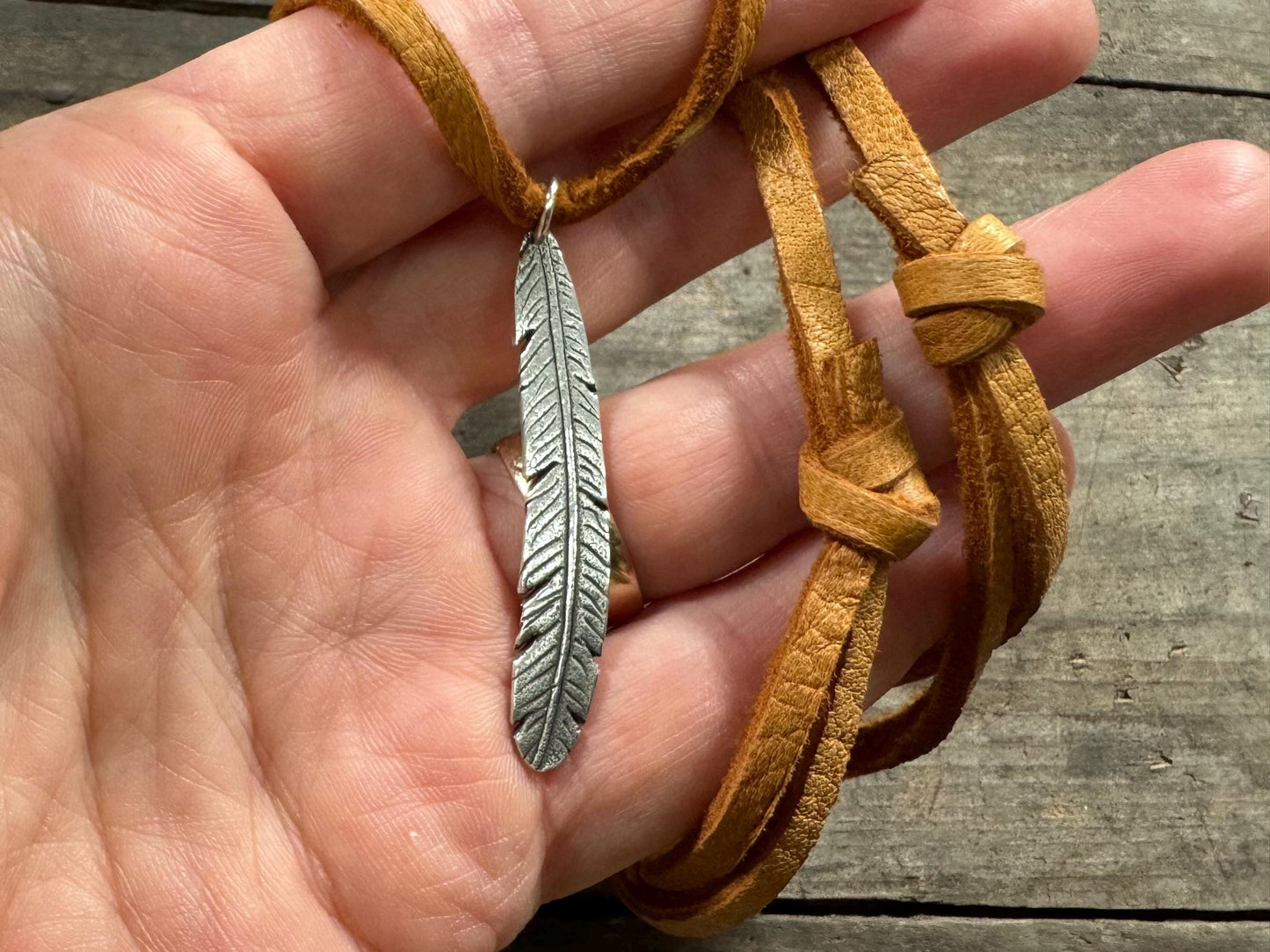 Tribal style silver feather necklace on leather or chain