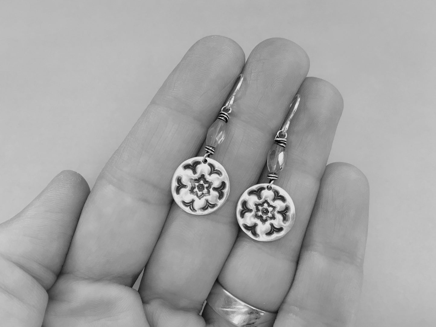 Silver stamped flower earrings with green peridot