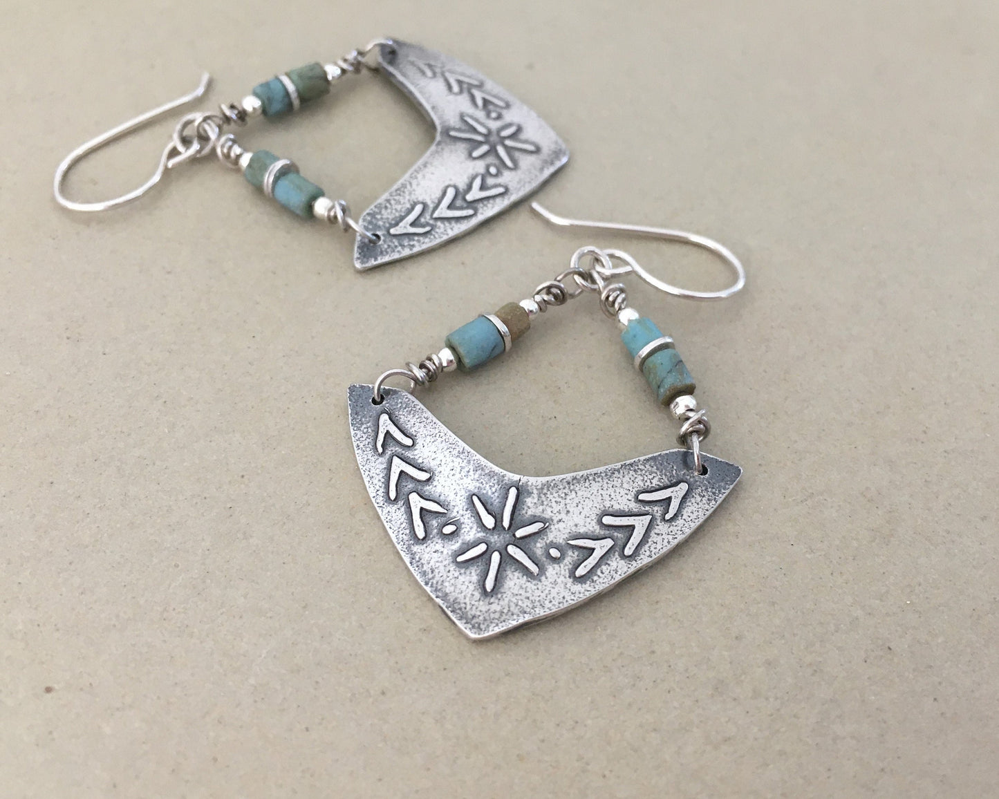 Silver boomerang earrings with blue stone beads