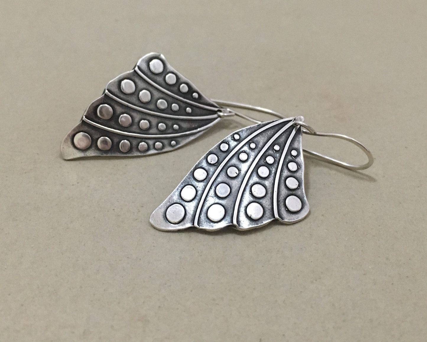 Silver butterfly wing earrings with polka dots