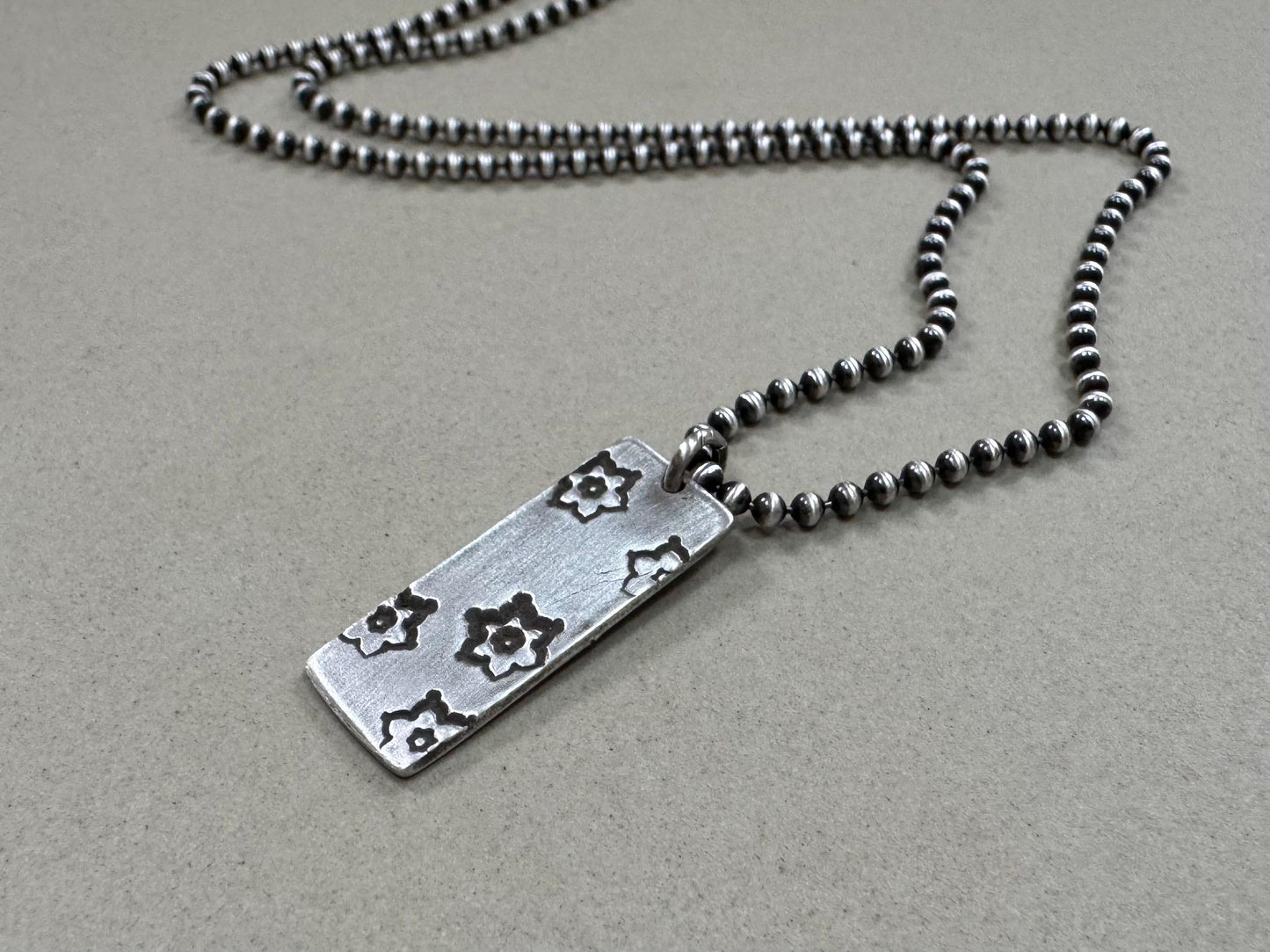 Silver stamped flower dog tag necklace