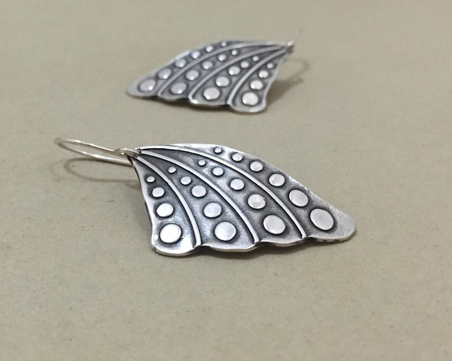 Silver butterfly wing earrings with polka dots