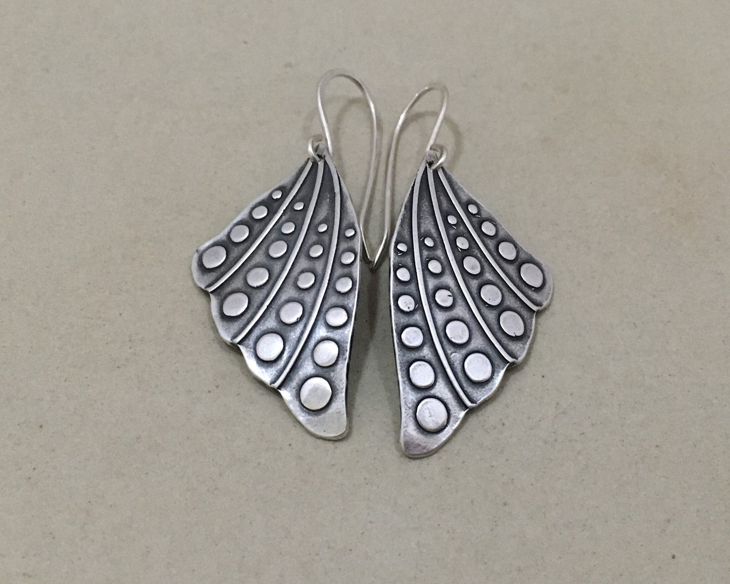 Silver butterfly wing earrings with polka dots
