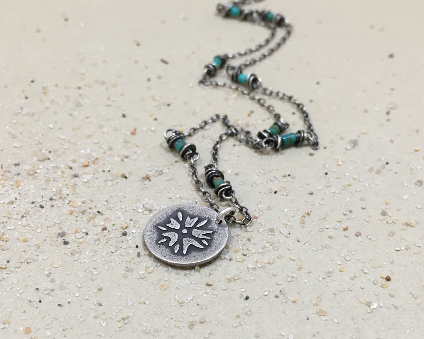Silver flower charm on turquoise beaded chain