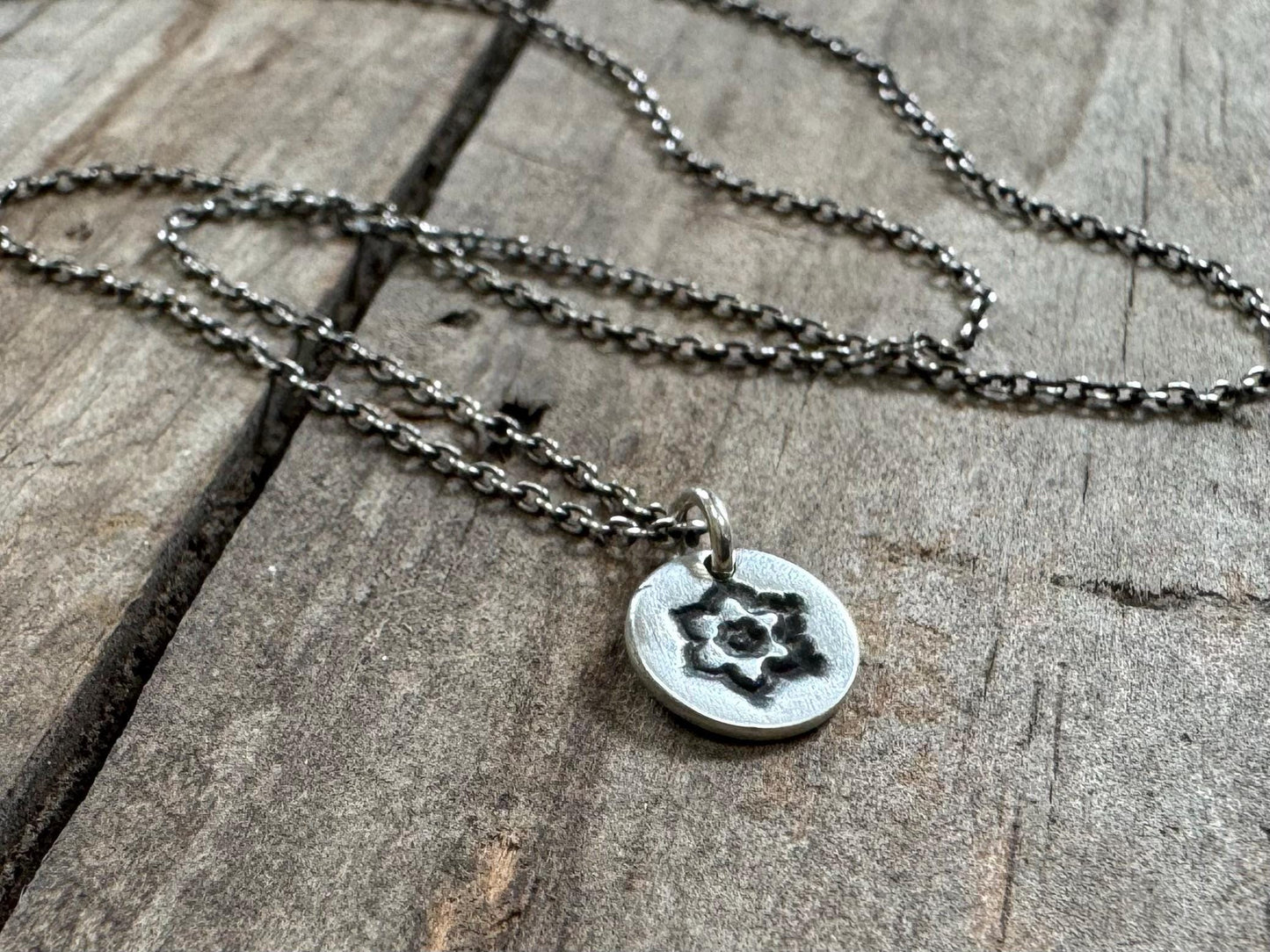 Tiny stamped flower necklace in oxidized sterling silver