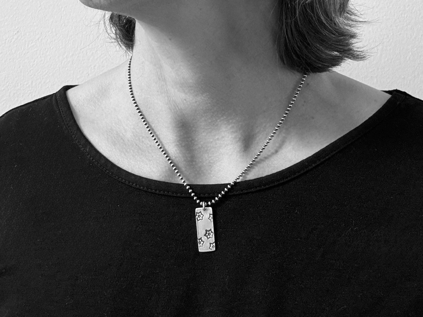 Silver stamped flower dog tag necklace