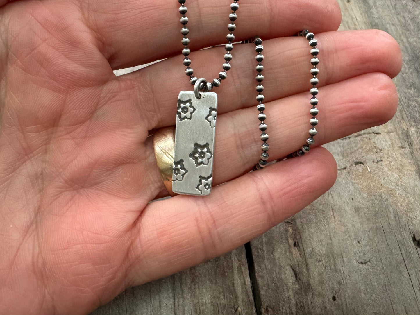 Silver stamped flower dog tag necklace