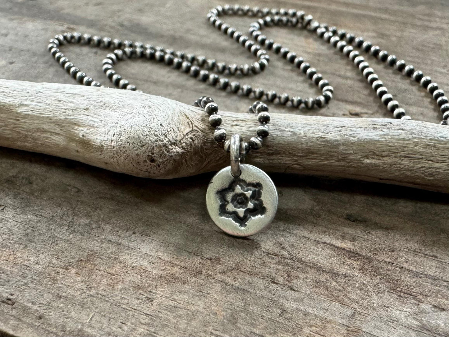 Tiny stamped flower necklace in oxidized sterling silver