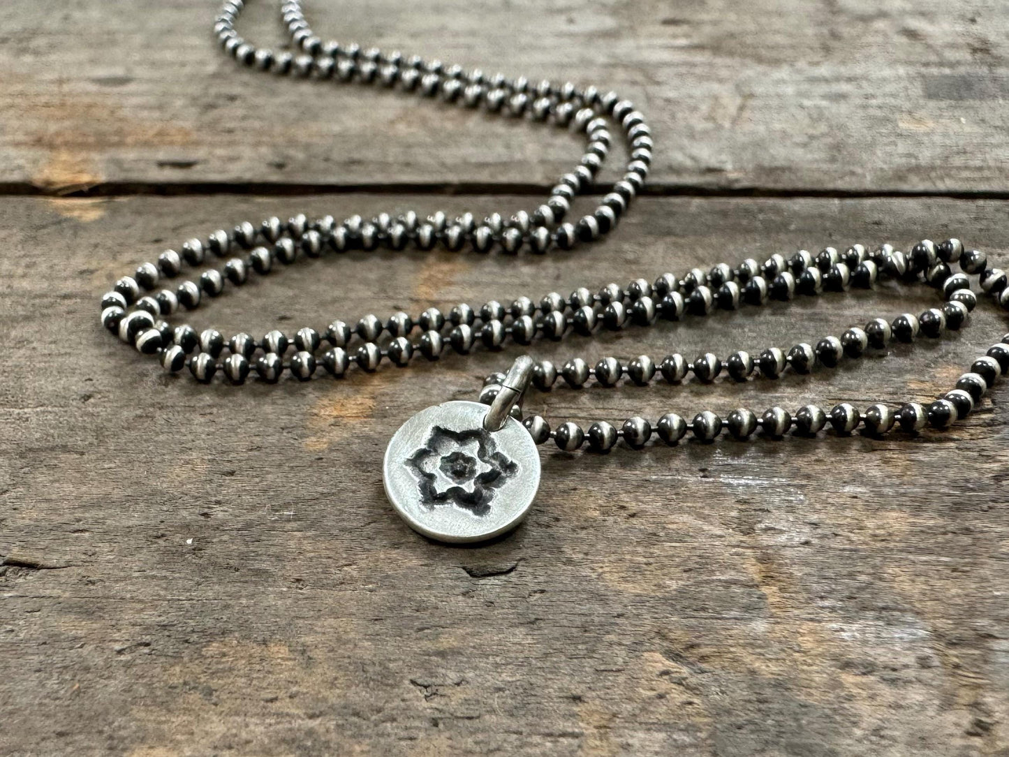 Tiny stamped flower necklace in oxidized sterling silver