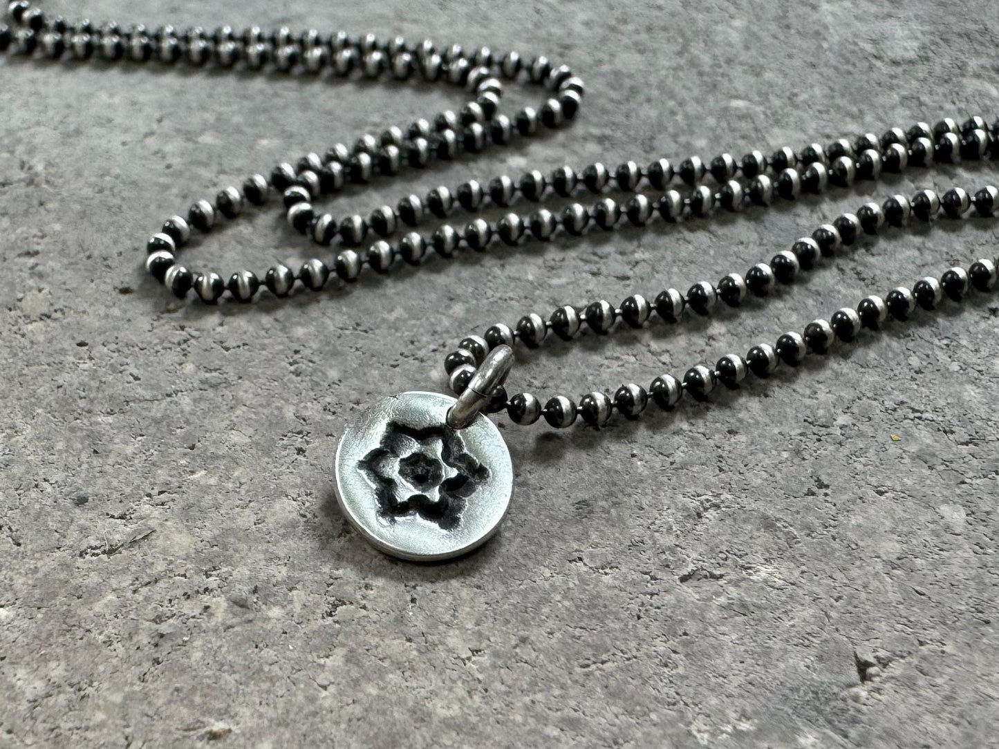 Tiny stamped flower necklace in oxidized sterling silver