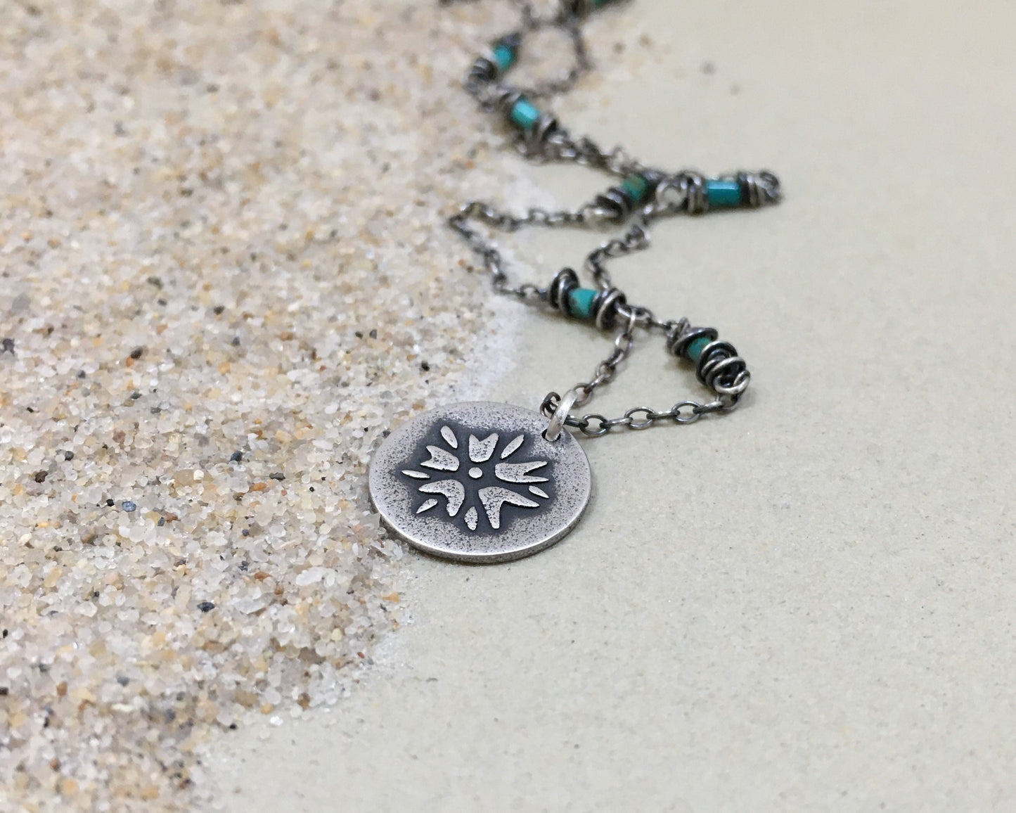 Silver flower charm on turquoise beaded chain