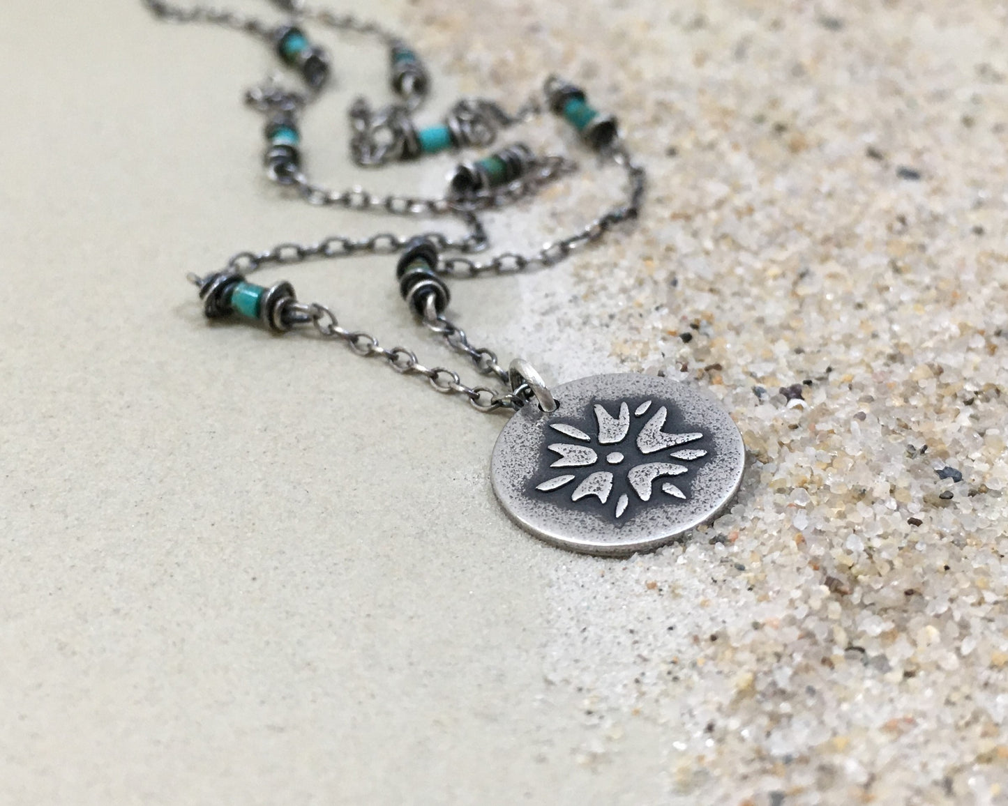 Silver flower charm on turquoise beaded chain