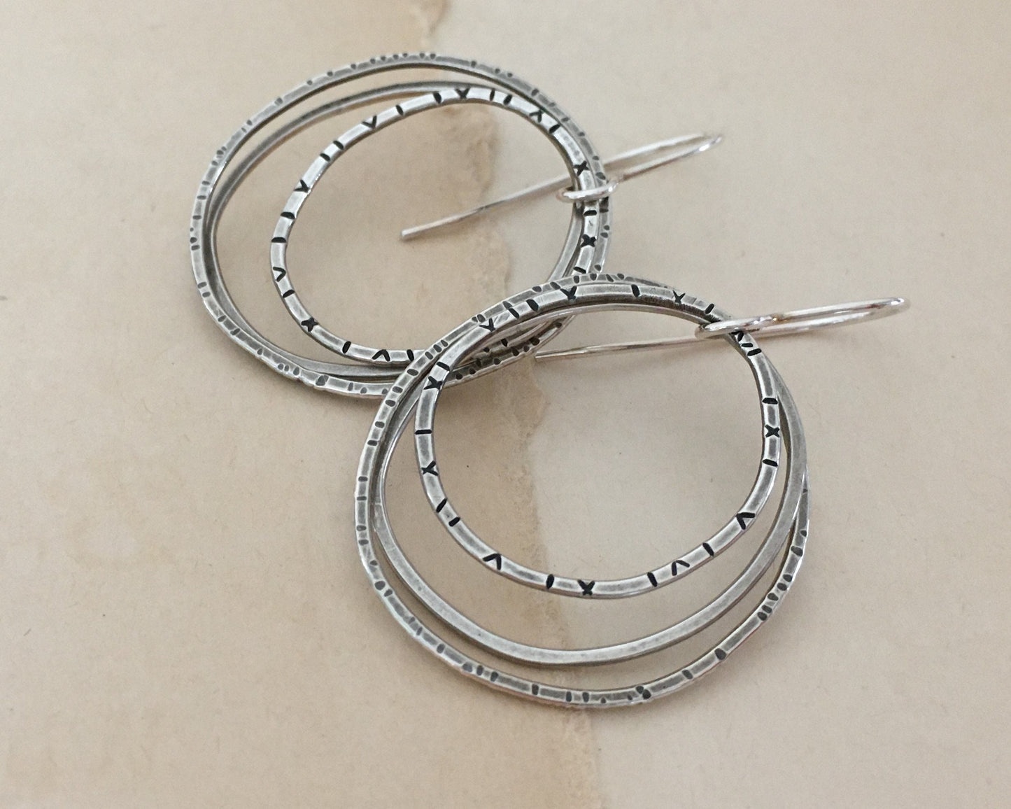 Multiple textured hoop earrings in oxidized sterling silver
