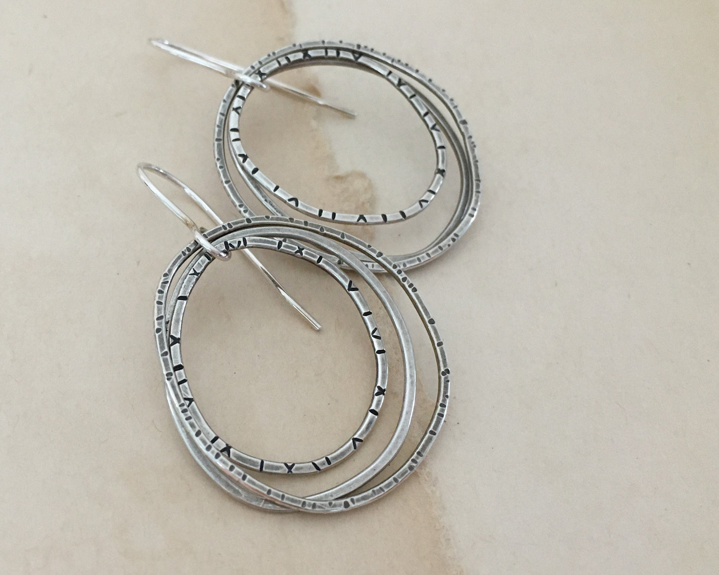 Multiple textured hoop earrings in oxidized sterling silver