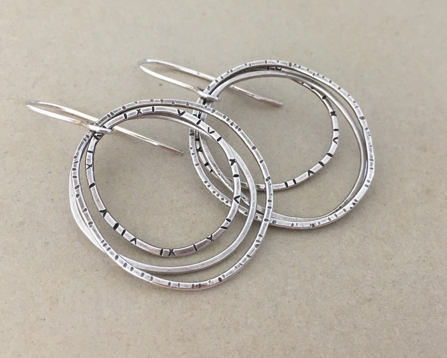 Multiple textured hoop earrings in oxidized sterling silver