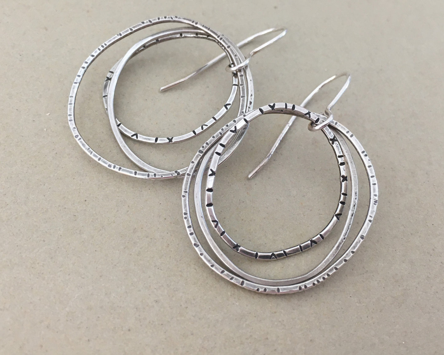 Multiple textured hoop earrings in oxidized sterling silver