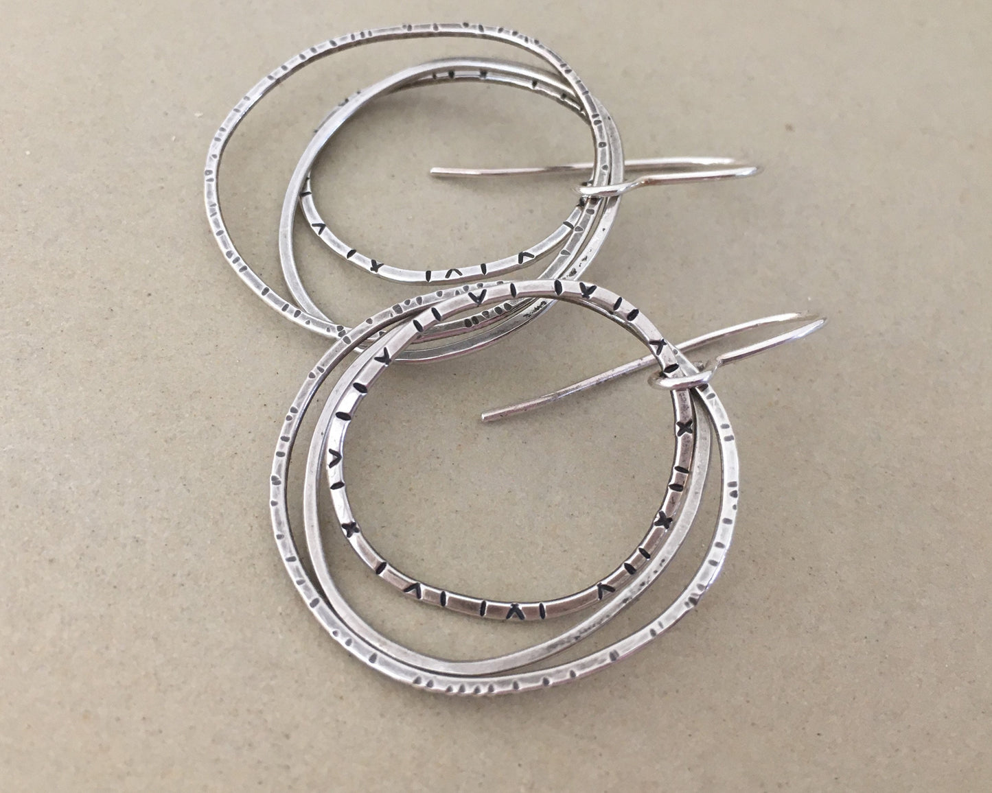 Multiple textured hoop earrings in oxidized sterling silver