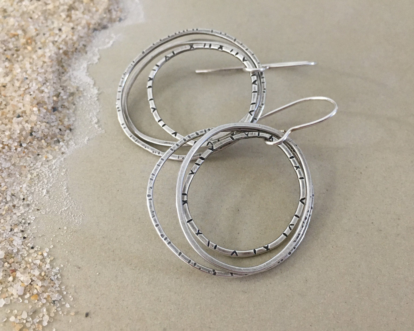 Multiple textured hoop earrings in oxidized sterling silver