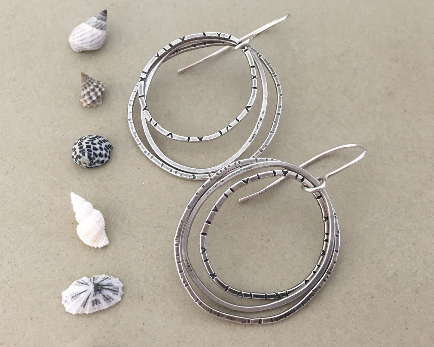 Multiple textured hoop earrings in oxidized sterling silver