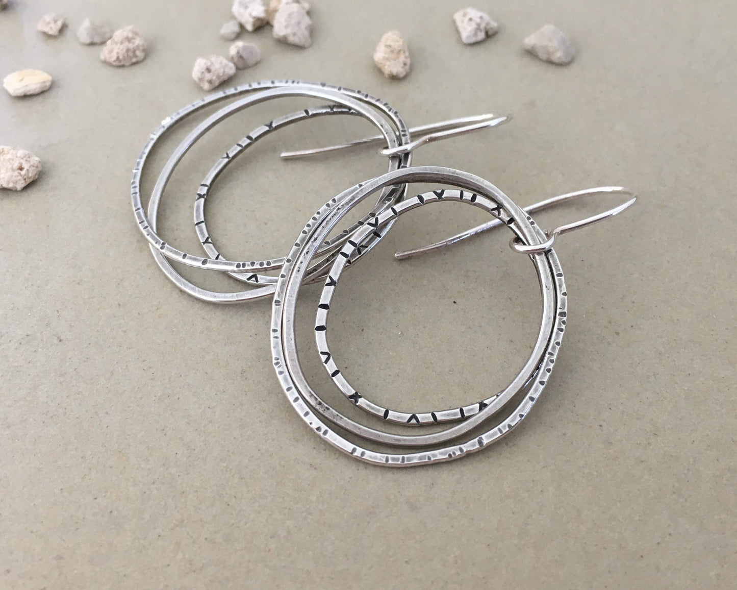 Multiple textured hoop earrings in oxidized sterling silver