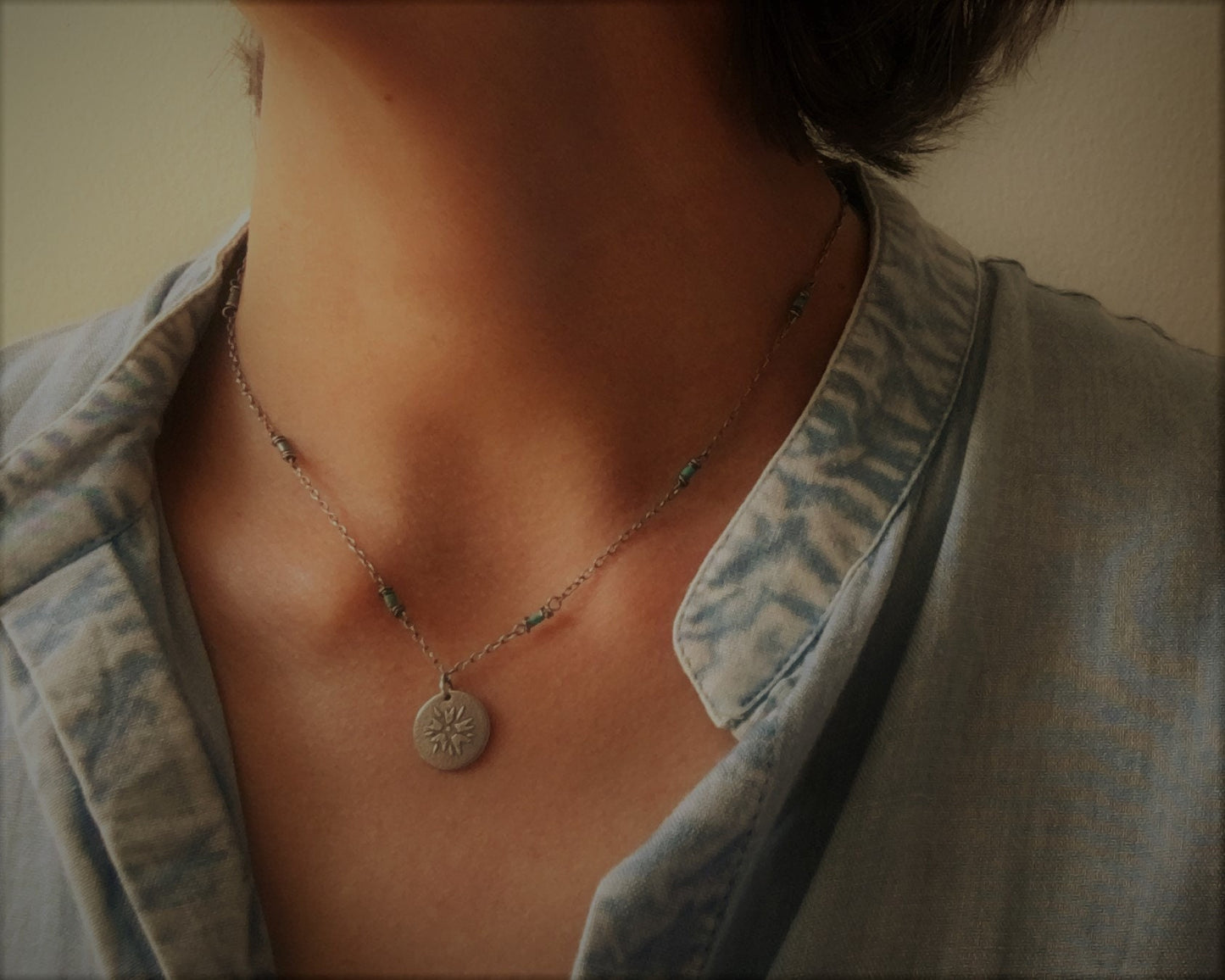 Silver flower charm on turquoise beaded chain