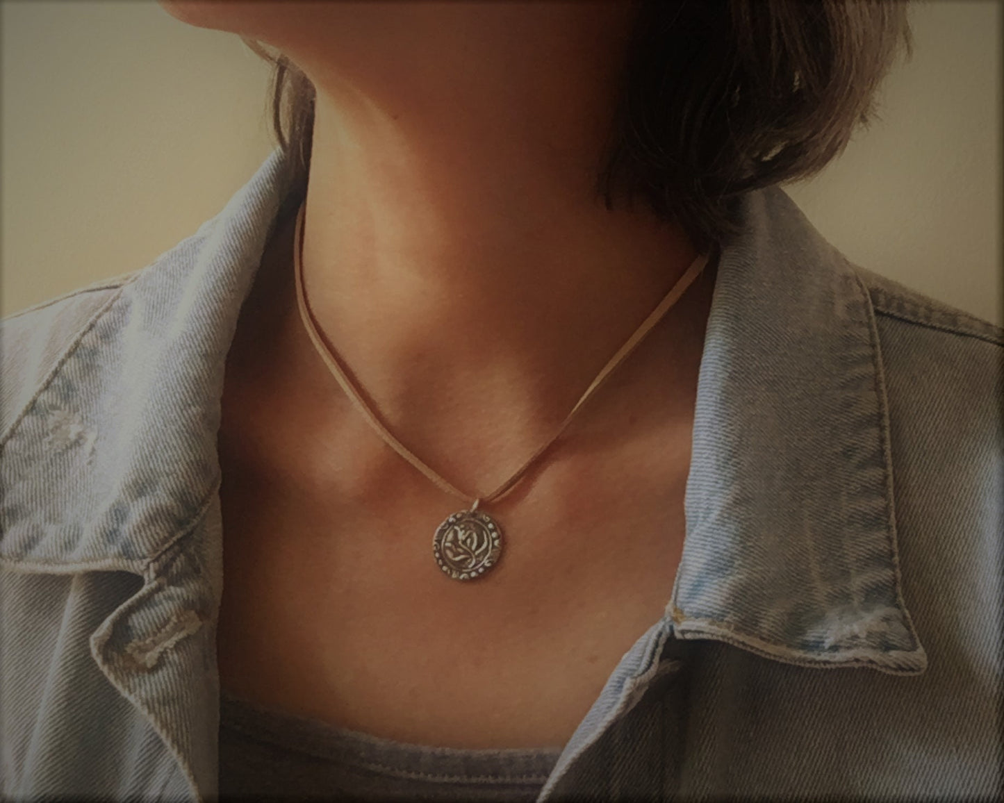 Silver floral medallion on soft leather lace