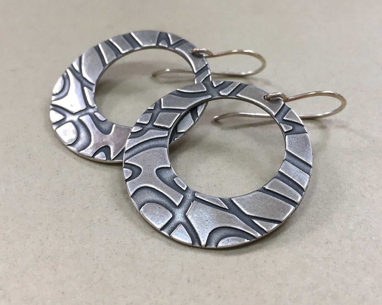 Stylized swirly hoops in oxidized sterling silver