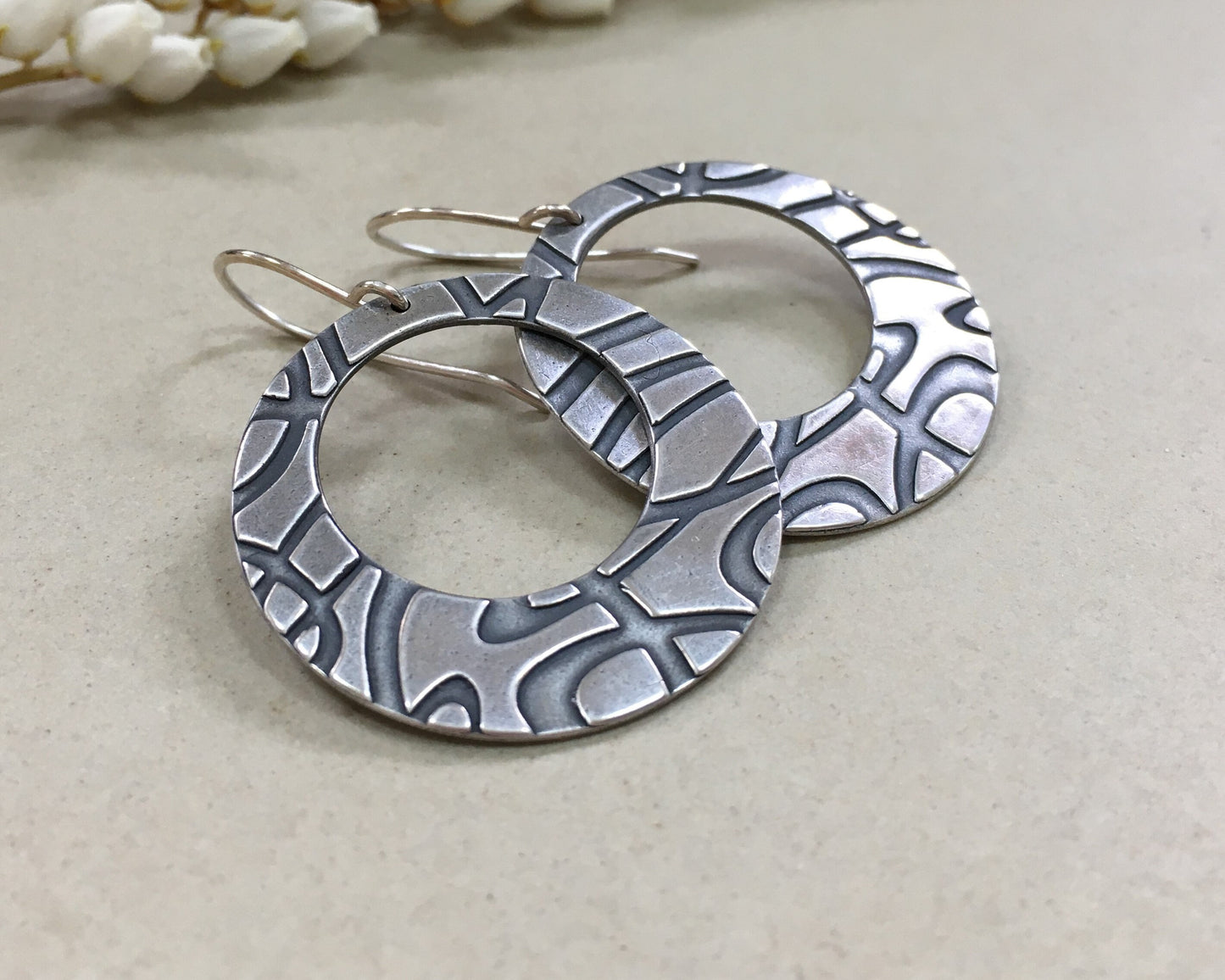 Stylized swirly hoops in oxidized sterling silver