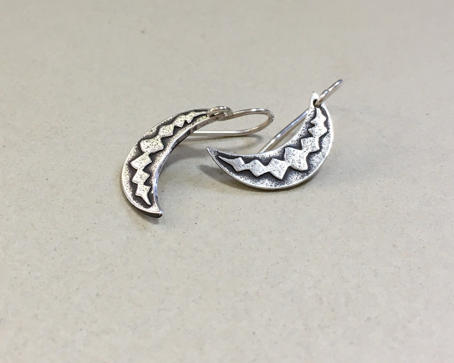 Silver crescent moon earrings with simple rustic design