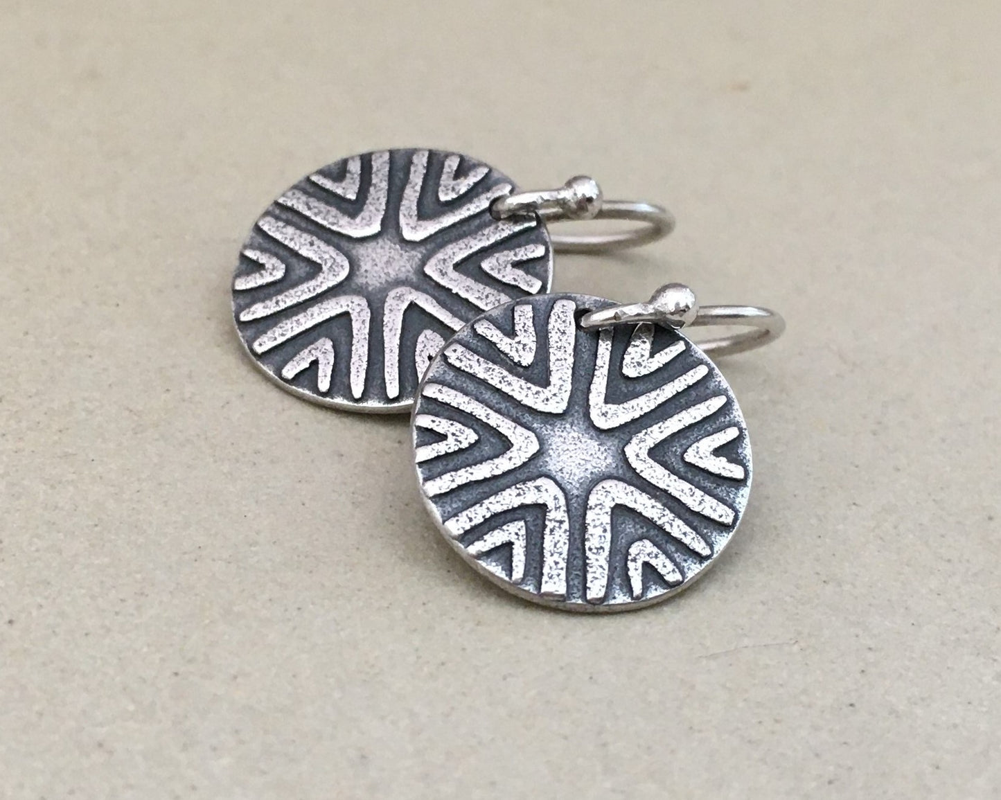 Primitive geometric discs in oxidized sterling silver