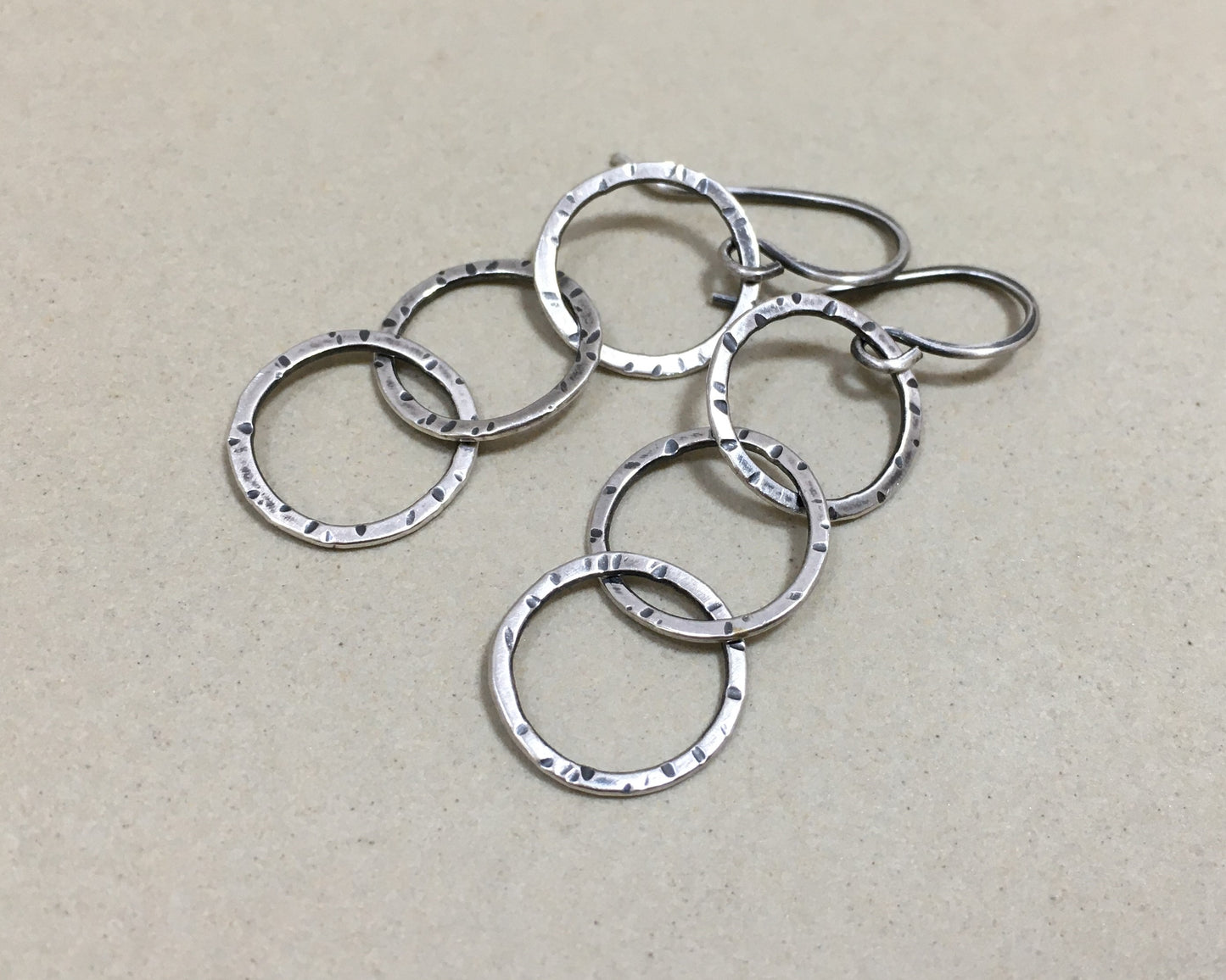 Triple linked textured hoops in oxidized sterling silver