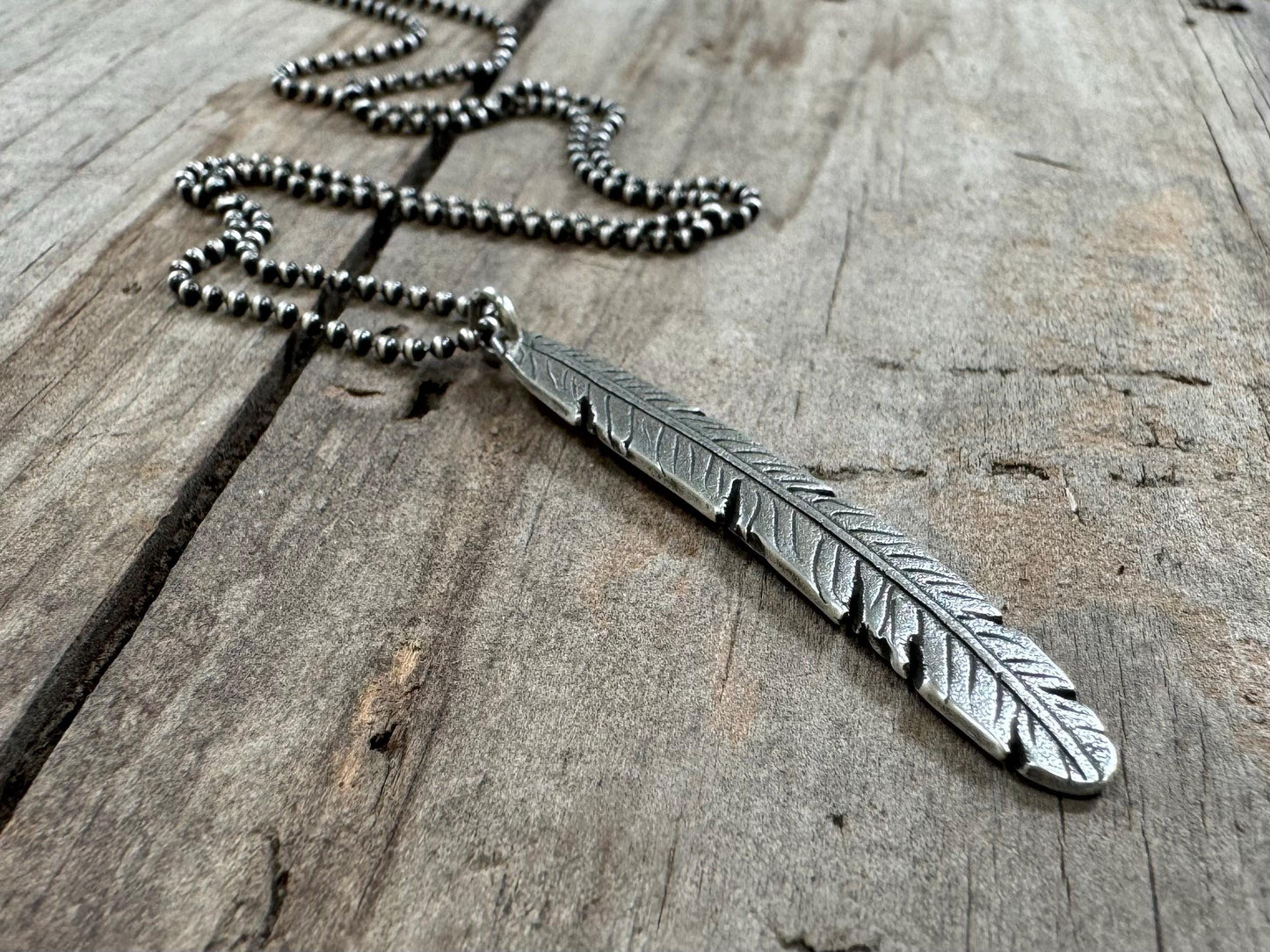 Tribal style silver feather necklace on leather or chain