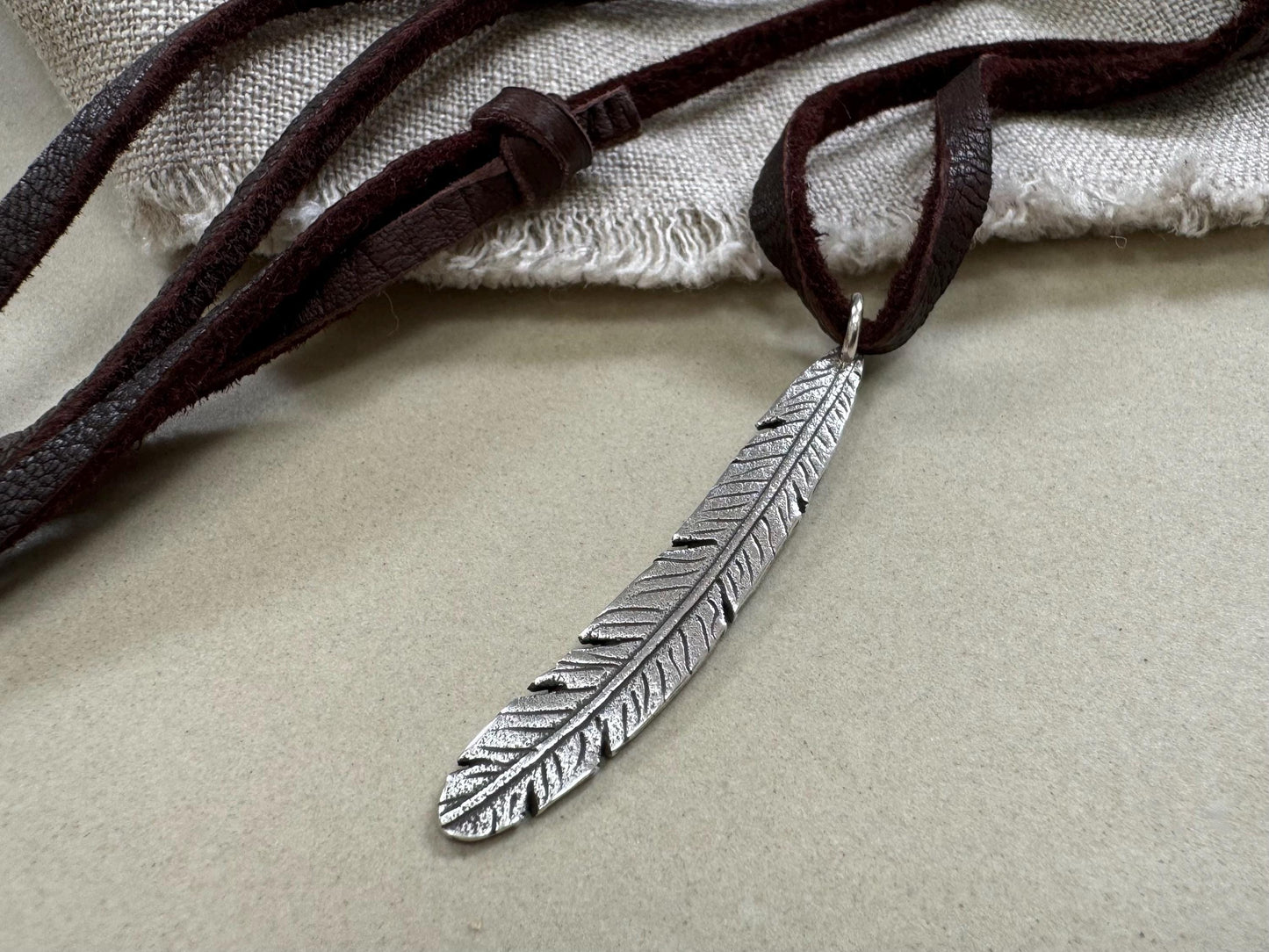 Tribal style silver feather necklace on leather or chain