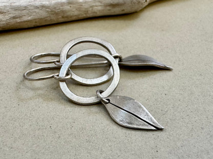 Little silver hoops with simple leaves in a brushed satin finish