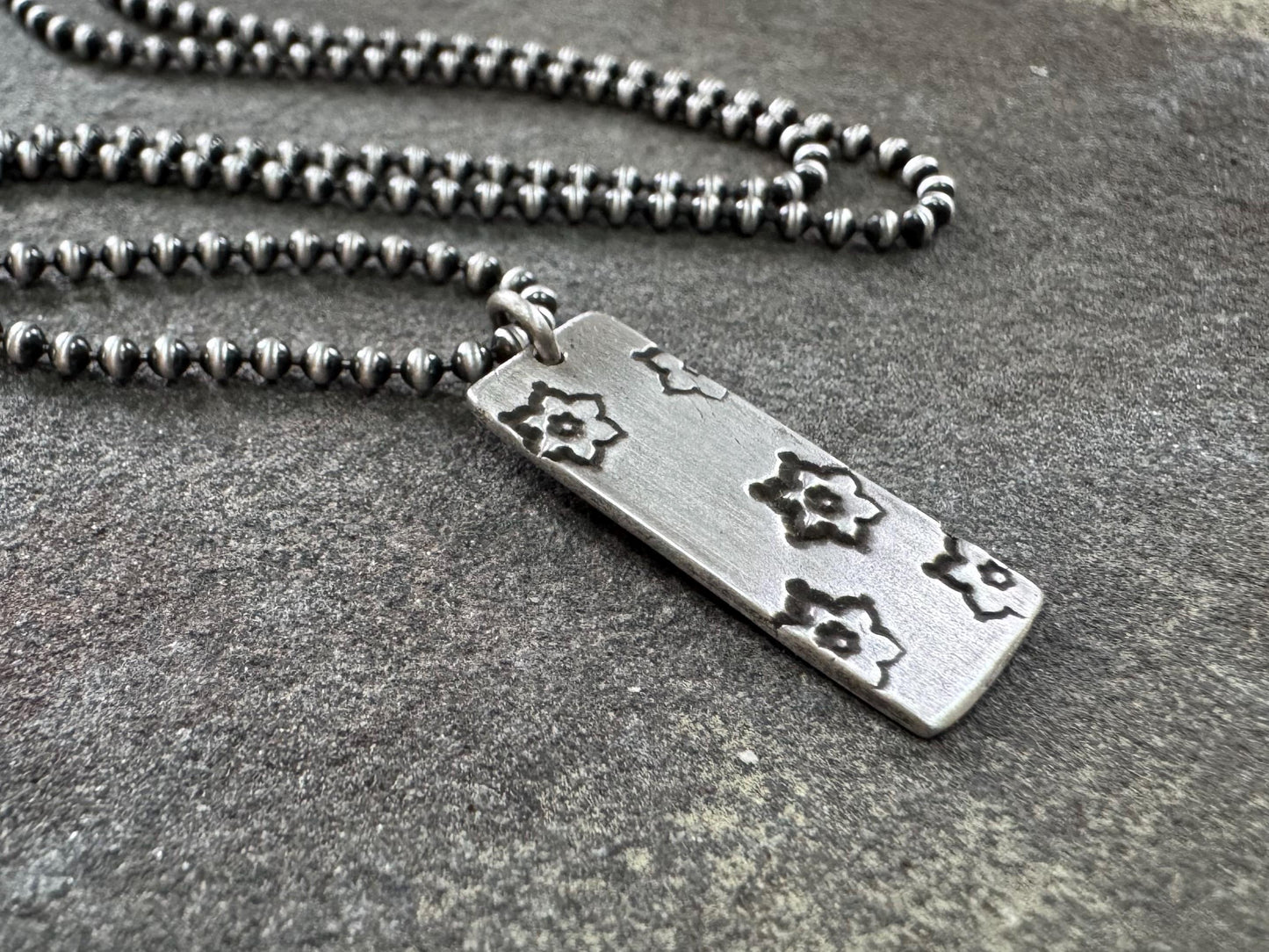 Silver stamped flower dog tag necklace