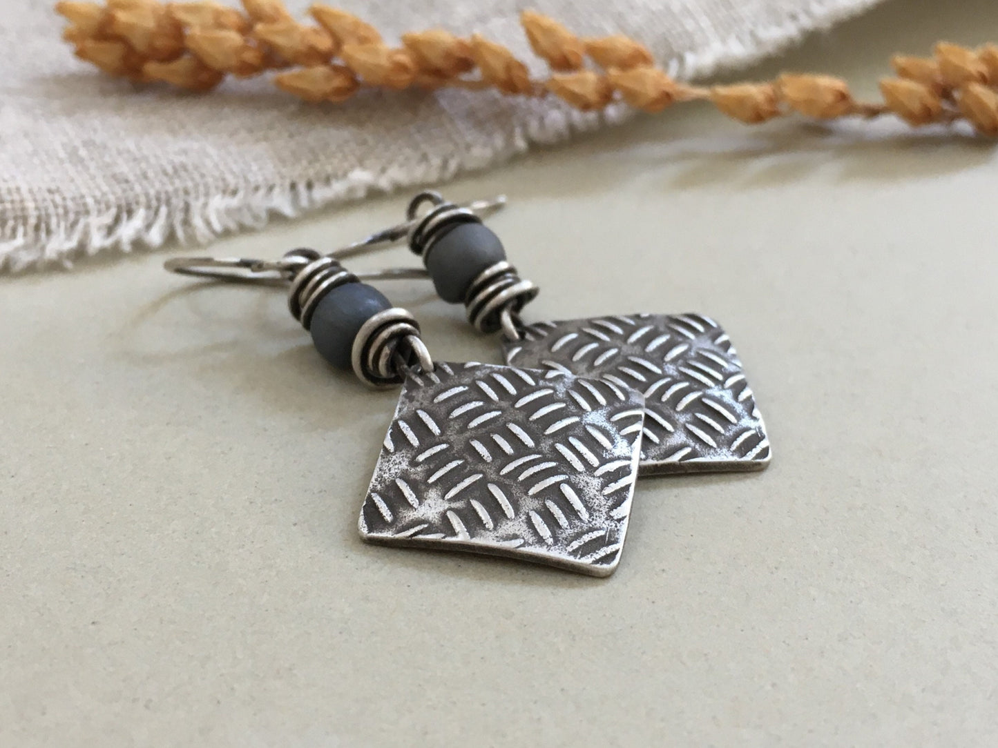 Sashiko cross stitch earrings in oxidized sterling silver with gray Java glass bead