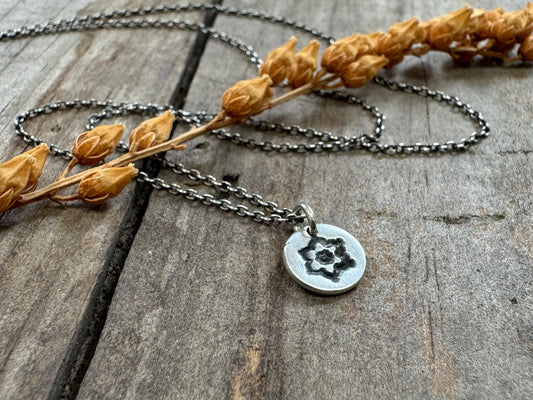 Tiny stamped flower necklace in oxidized sterling silver