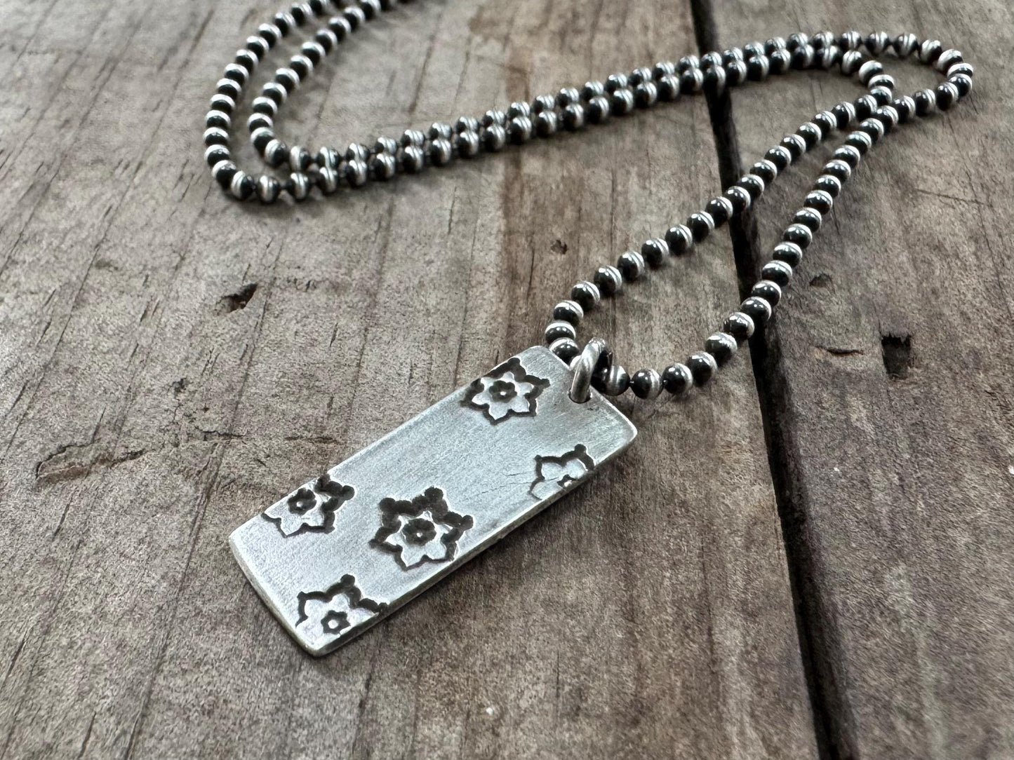 Silver stamped flower dog tag necklace