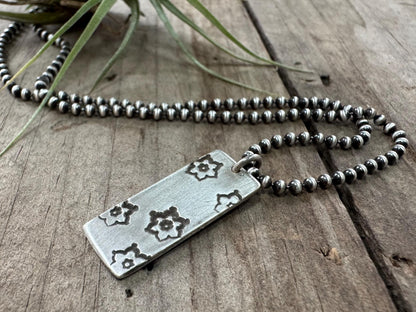 Silver stamped flower dog tag necklace