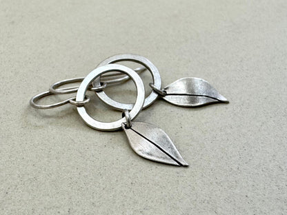Little silver hoops with simple leaves in a brushed satin finish
