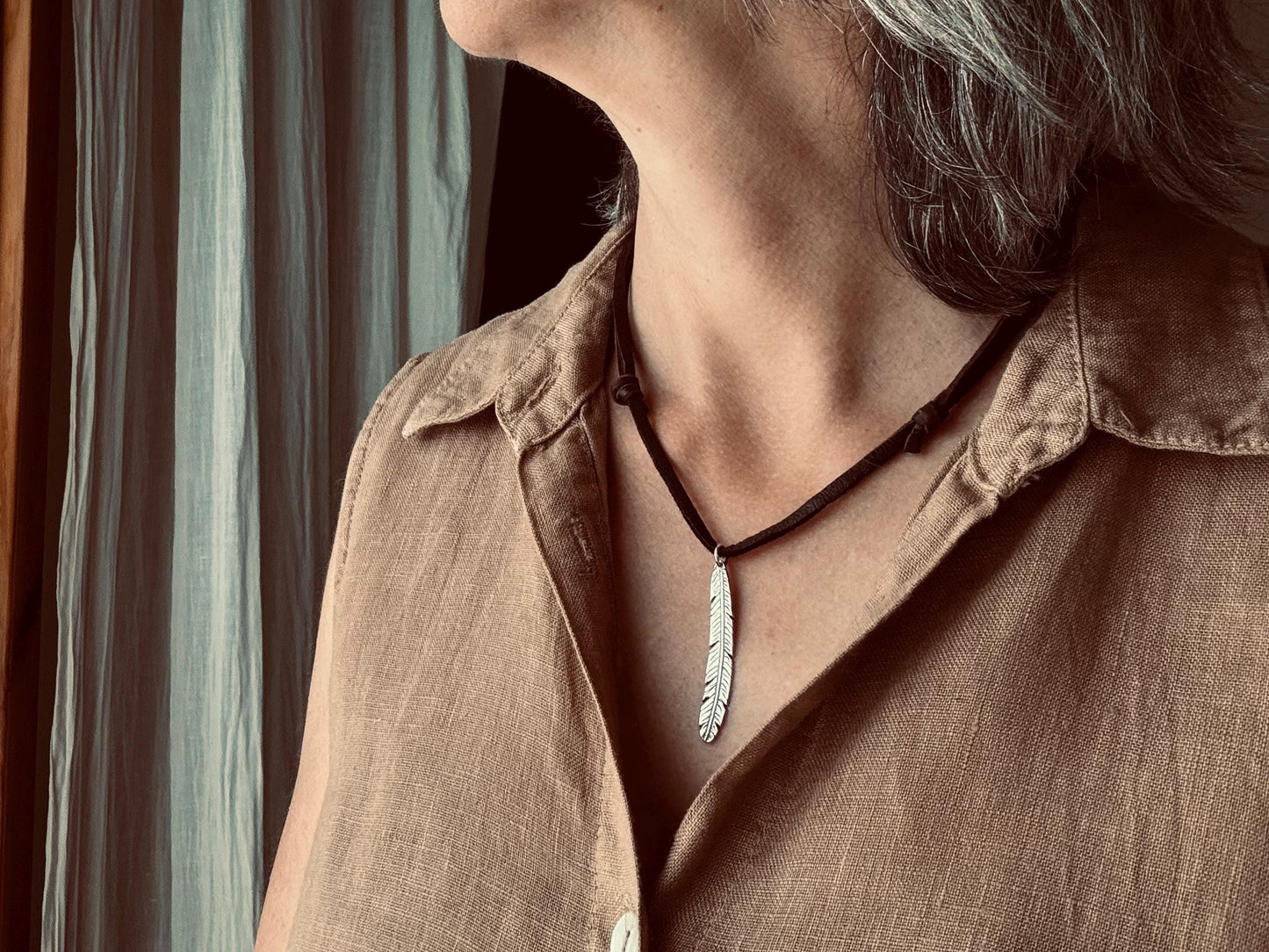 Tribal style silver feather necklace on leather or chain