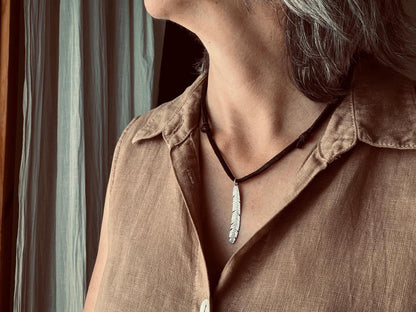 Tribal style silver feather necklace on leather or chain