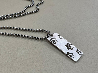 Silver stamped flower dog tag necklace