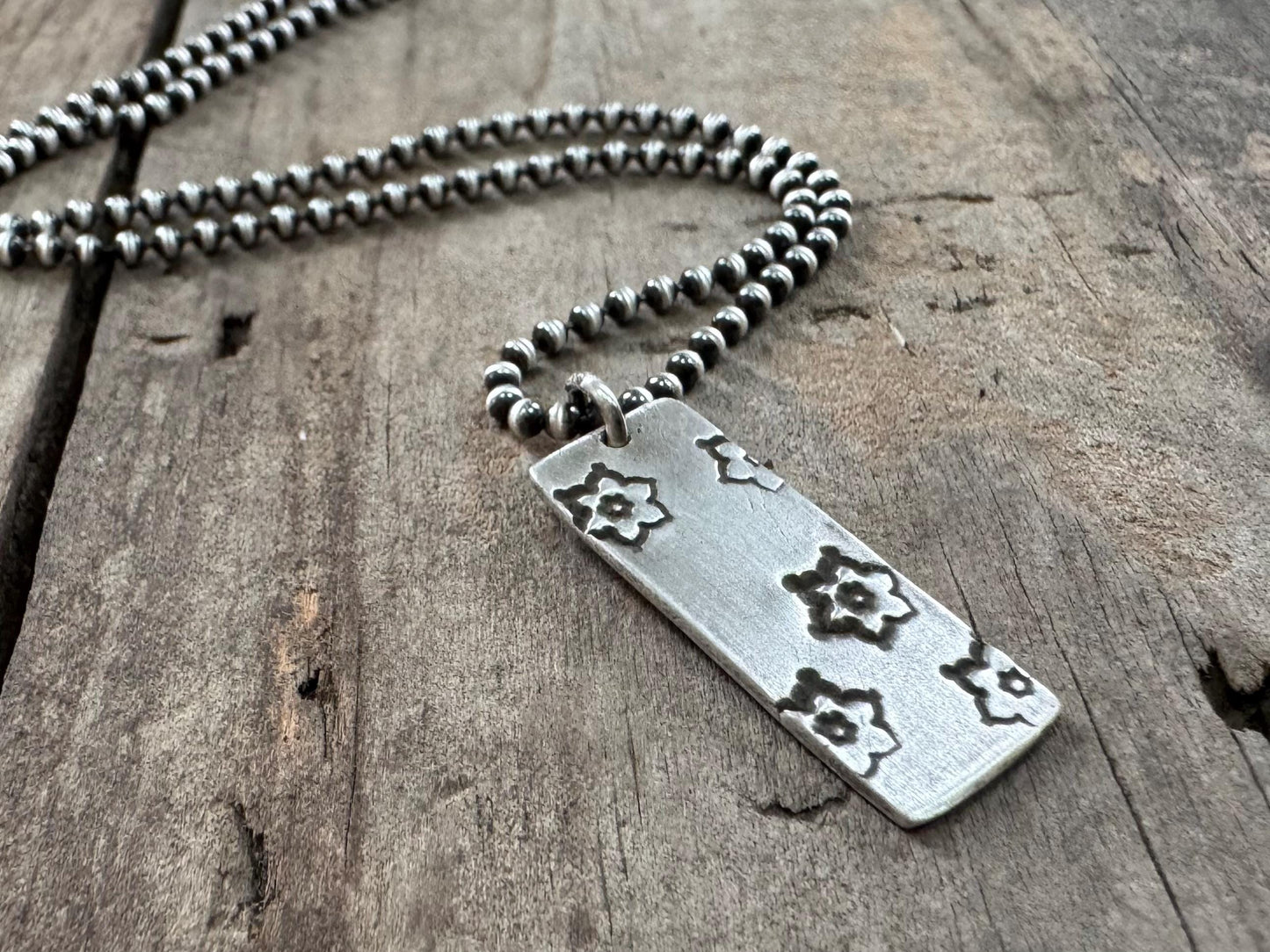 Silver stamped flower dog tag necklace