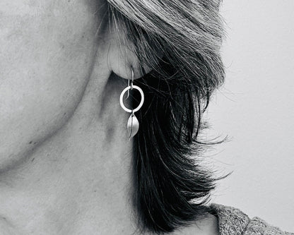 Little silver hoops with simple leaves in a brushed satin finish