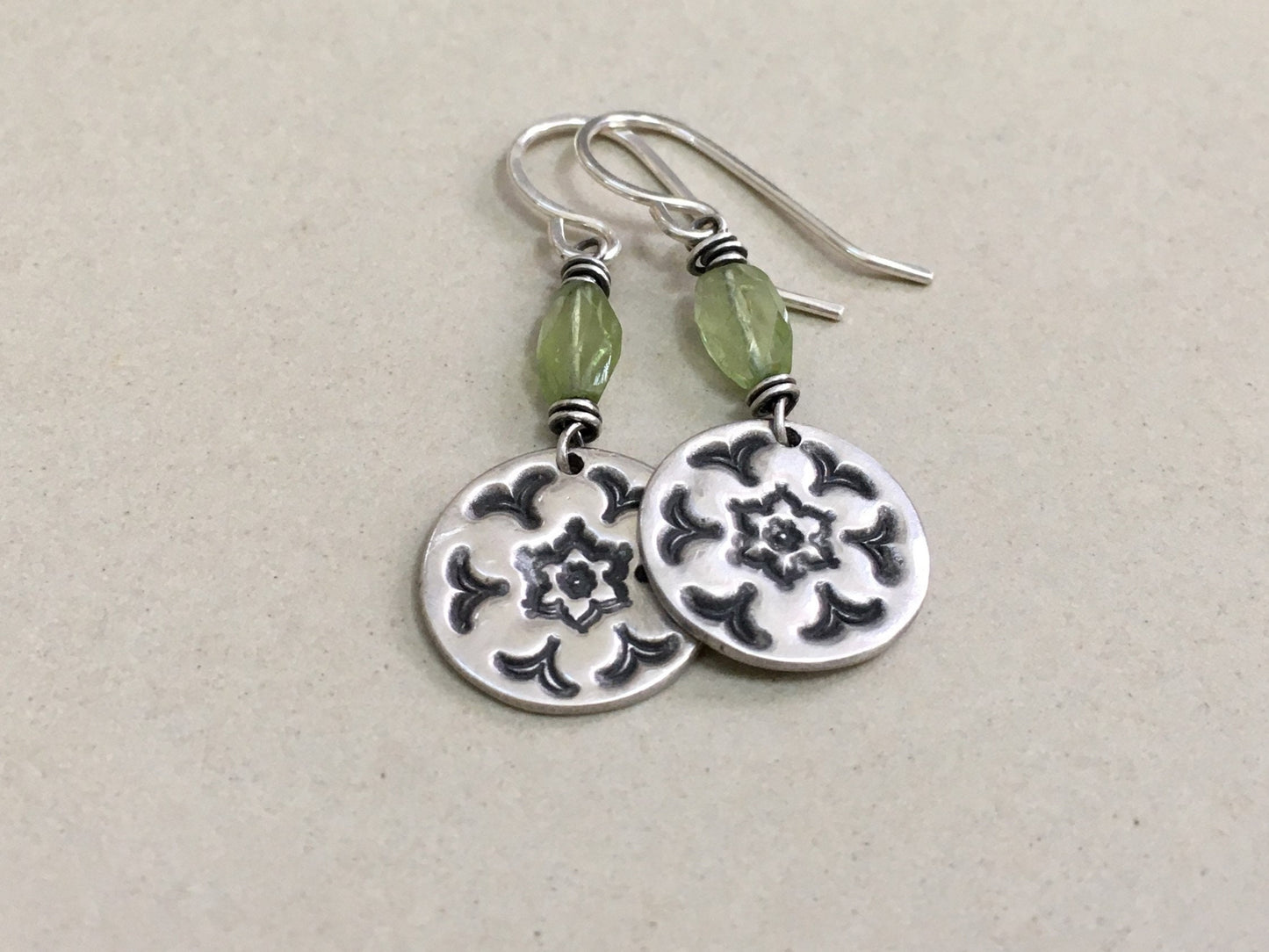 Silver stamped flower earrings with green peridot